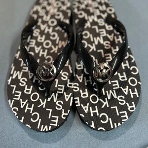 Michael Kors black flip flops, size 9M